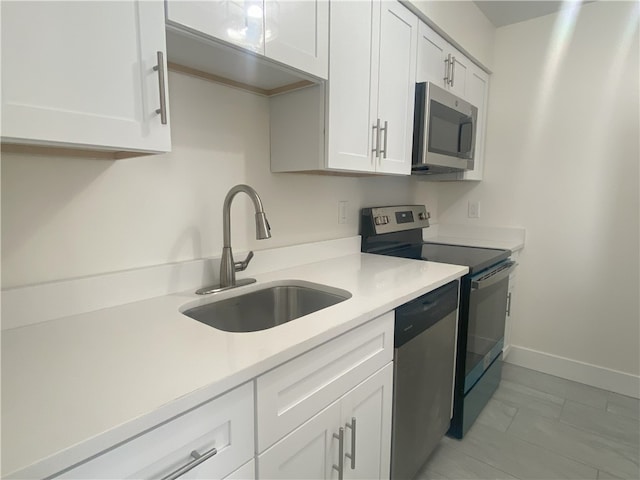 kitchen featuring white cabinetry, sink, and stainless steel appliances