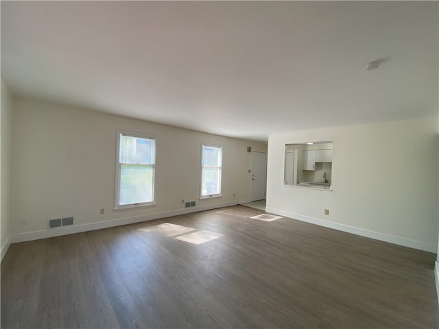 unfurnished living room with hardwood / wood-style flooring