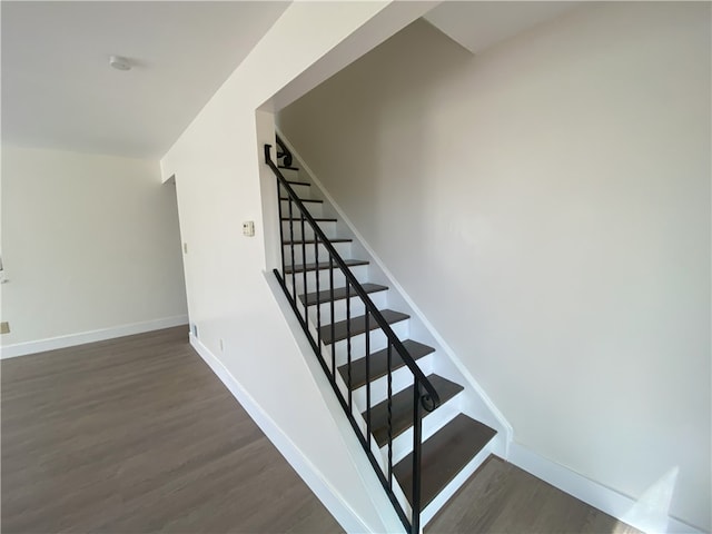 stairway with hardwood / wood-style floors