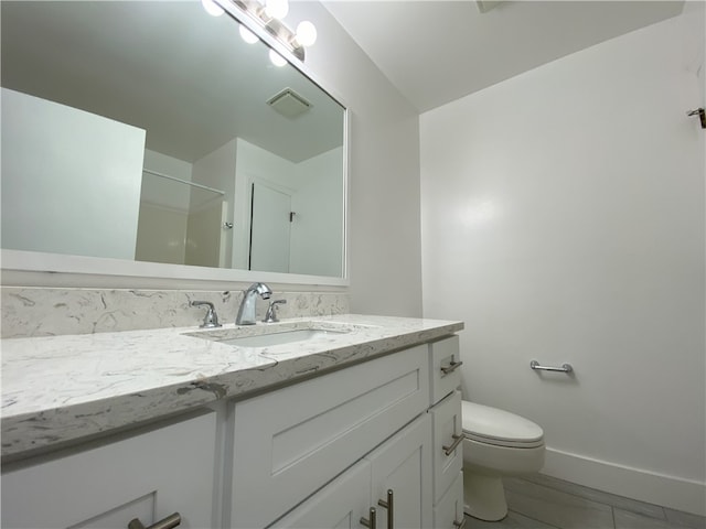 bathroom with tile patterned floors, toilet, and vanity