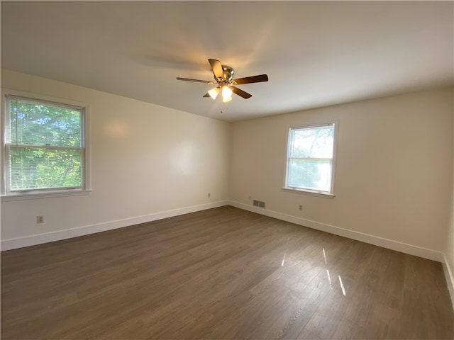 spare room featuring ceiling fan and dark hardwood / wood-style floors