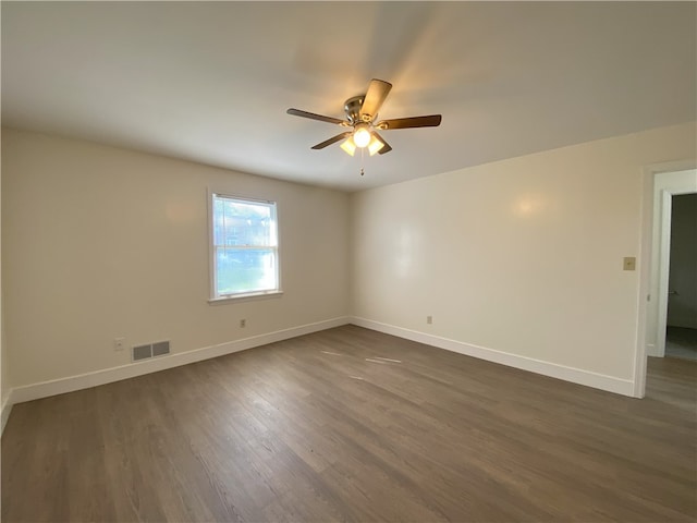 spare room with ceiling fan and dark hardwood / wood-style floors