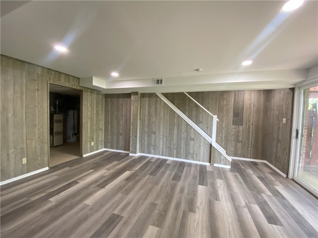 interior space with wood walls and hardwood / wood-style flooring