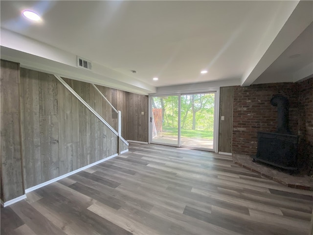 32 Bracken Pl, Plum Boro, PA 15239 - unfurnished living room featuring wood finished floors, stairs, a wood stove, and recessed lighting