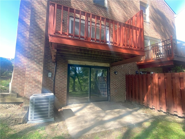 rear view of property with a patio area and cooling unit