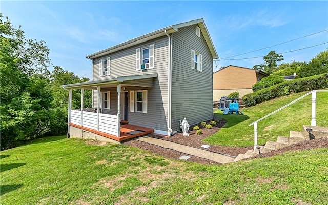 view of front of property with covered porch and a front lawn