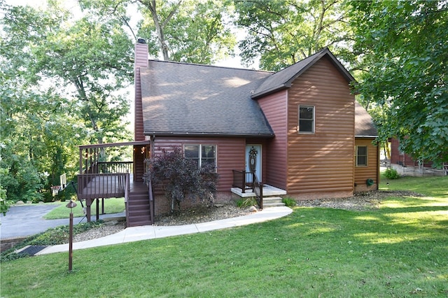 rear view of property with a deck and a yard