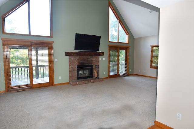 unfurnished living room featuring a fireplace, carpet, and high vaulted ceiling