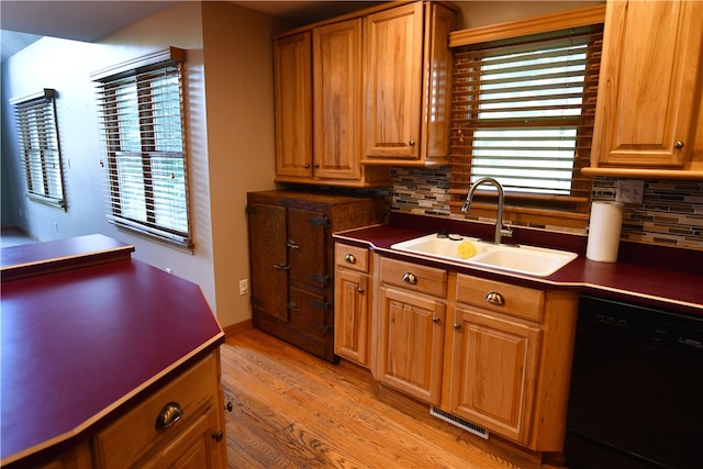 kitchen with black dishwasher, plenty of natural light, and tasteful backsplash