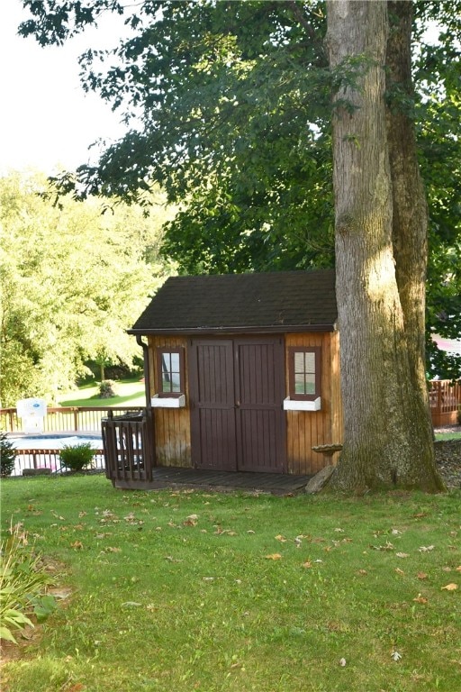 view of home's exterior featuring a yard and an outbuilding