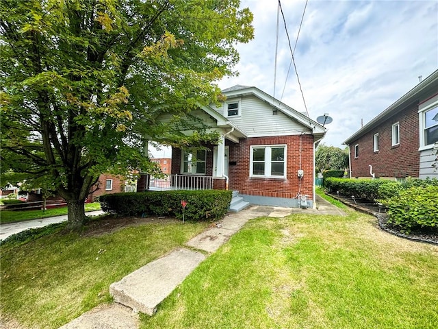 bungalow-style house featuring a front lawn and brick siding