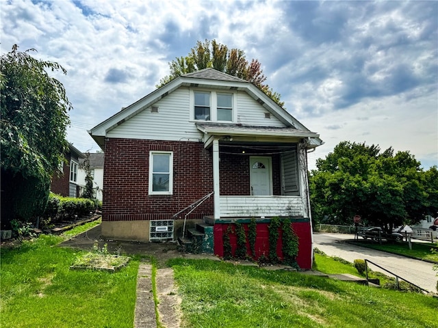 bungalow-style home with a front lawn