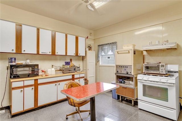 kitchen featuring white cabinets, white range with gas cooktop, and ceiling fan