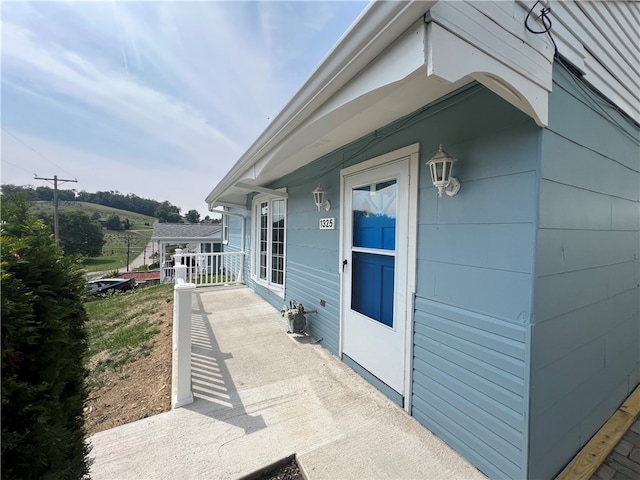 view of side of home with covered porch