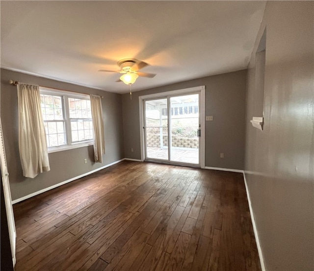 spare room featuring ceiling fan and dark hardwood / wood-style floors