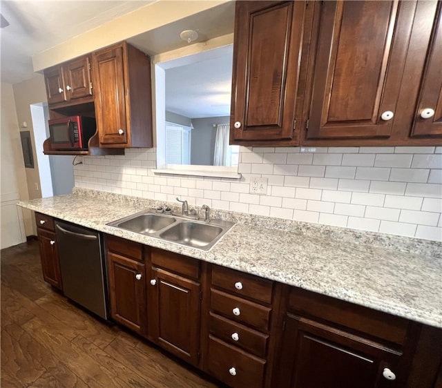 kitchen with dark hardwood / wood-style flooring, tasteful backsplash, appliances with stainless steel finishes, light stone countertops, and sink