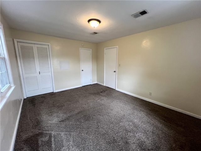 unfurnished bedroom featuring carpet floors and a closet