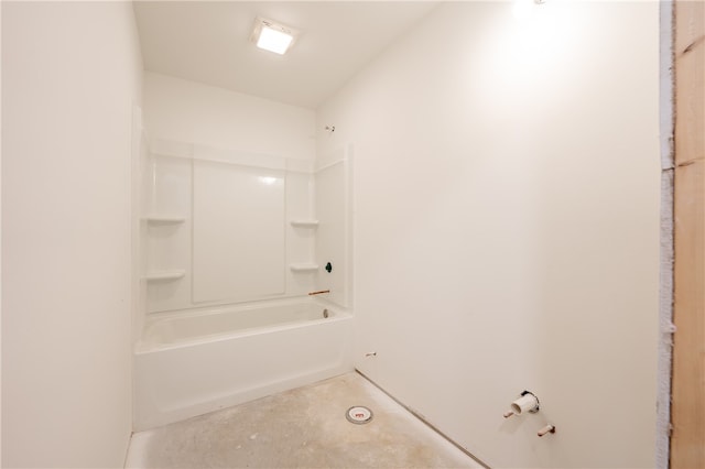 bathroom with bathtub / shower combination and concrete floors