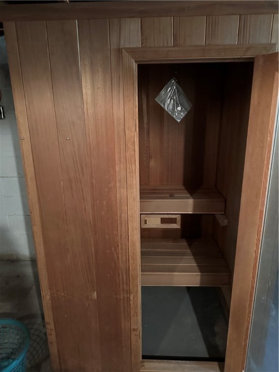 view of sauna featuring wooden walls