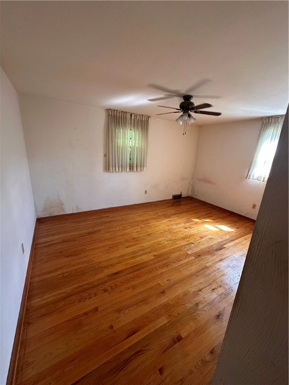 unfurnished room featuring ceiling fan and light wood-type flooring