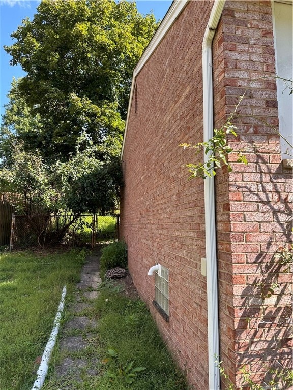 view of side of home with a lawn