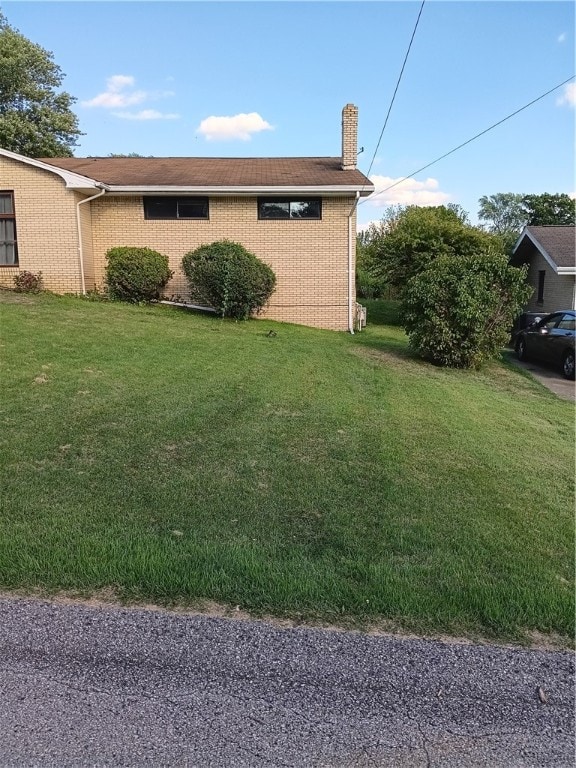 view of home's exterior with a lawn