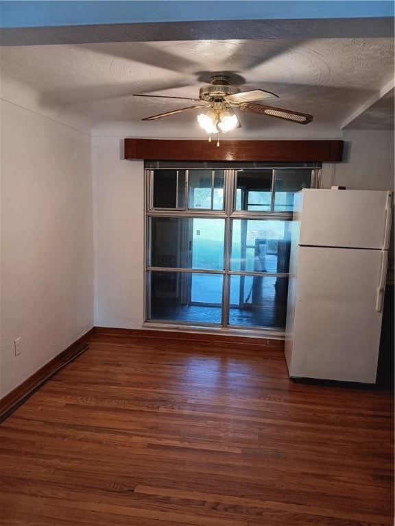 empty room featuring ceiling fan, hardwood / wood-style flooring, and a textured ceiling