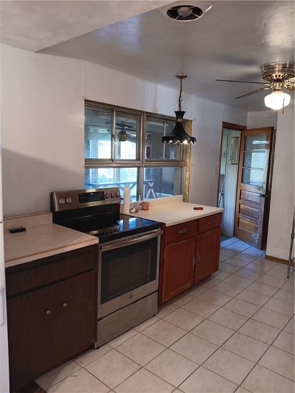 kitchen with decorative light fixtures, ceiling fan, stainless steel electric range oven, and light tile patterned floors