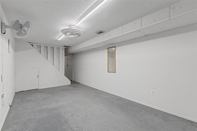 basement with carpet and a textured ceiling