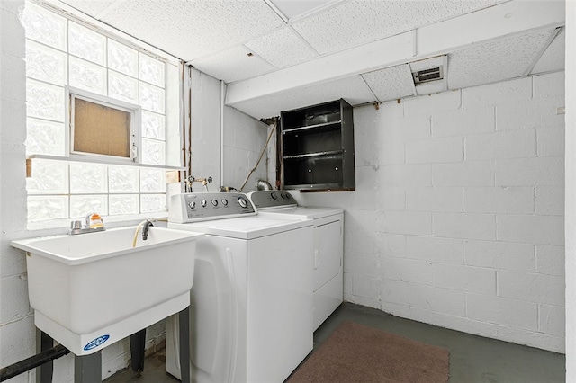 clothes washing area featuring sink and washing machine and clothes dryer