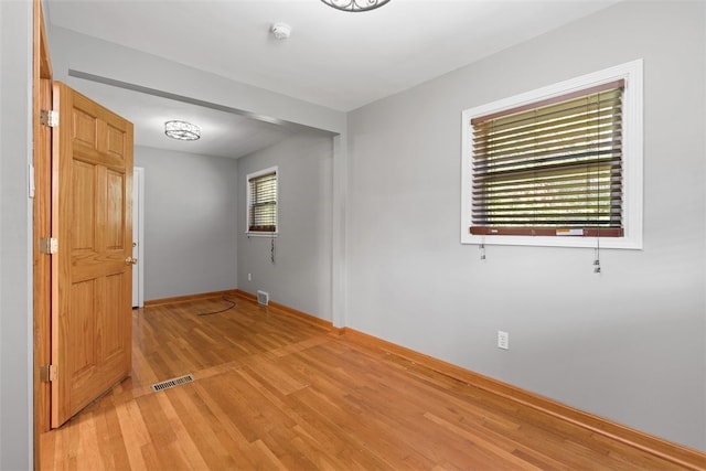 unfurnished room with light hardwood / wood-style flooring