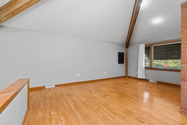 bonus room featuring vaulted ceiling with beams and light wood-type flooring