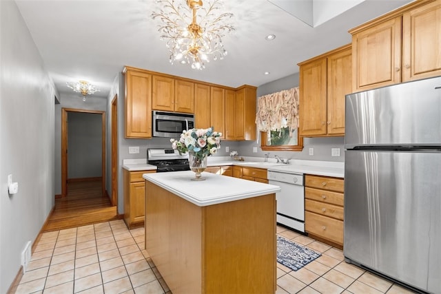 kitchen with sink, a center island, light tile patterned floors, pendant lighting, and stainless steel appliances