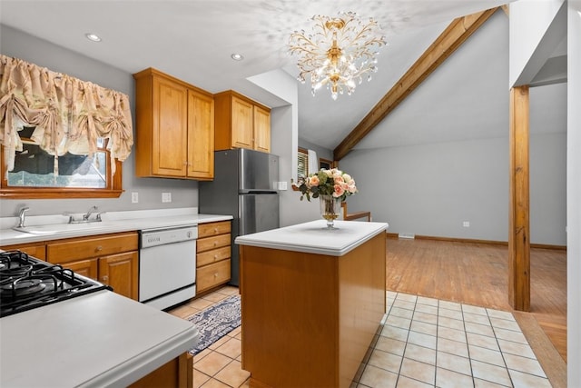 kitchen featuring sink, vaulted ceiling with beams, a center island, white dishwasher, and pendant lighting