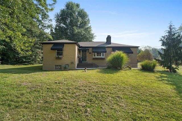 back of house with a lawn