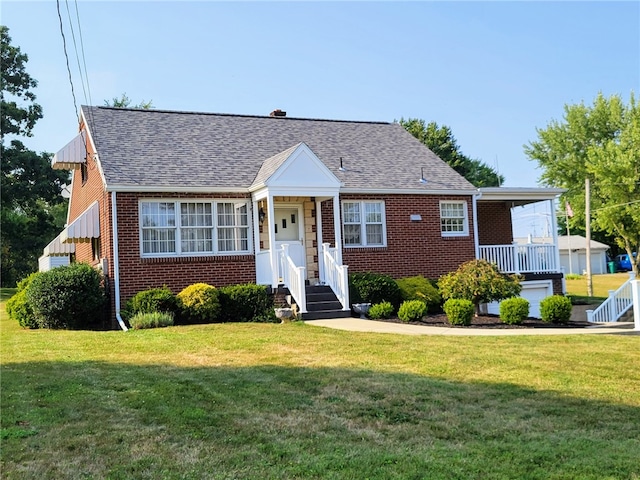 bungalow-style house featuring brick siding, a front lawn, and a shingled roof