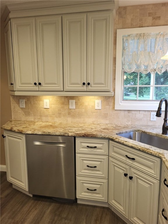 kitchen with decorative backsplash, stainless steel dishwasher, dark hardwood / wood-style flooring, light stone counters, and sink