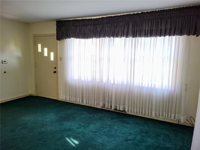 carpeted empty room featuring a wealth of natural light