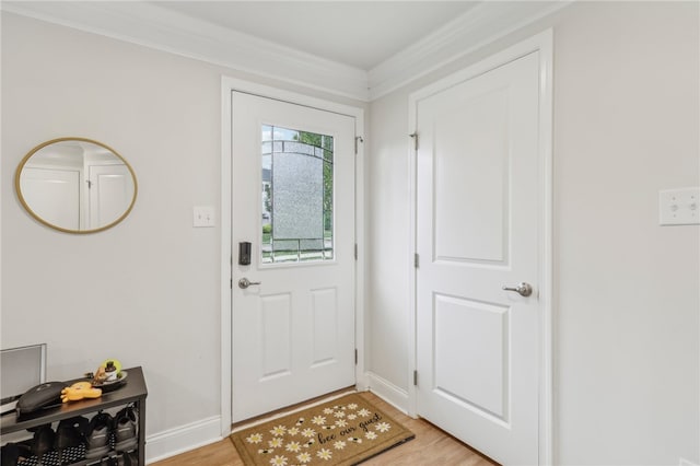 foyer featuring light wood-type flooring and ornamental molding