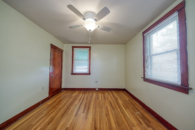 unfurnished room with ceiling fan and hardwood / wood-style flooring