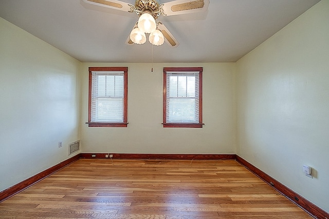 unfurnished room with ceiling fan and hardwood / wood-style floors