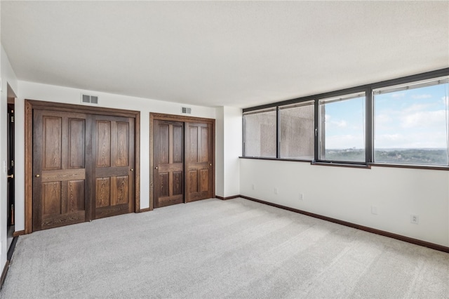 unfurnished bedroom with light colored carpet