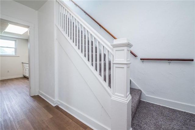 stairs with baseboards and wood finished floors