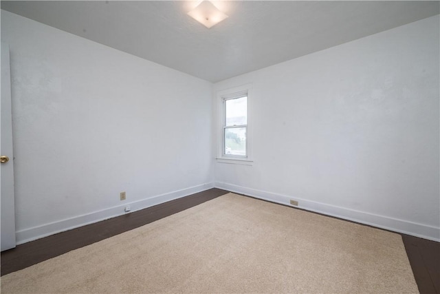 empty room featuring baseboards