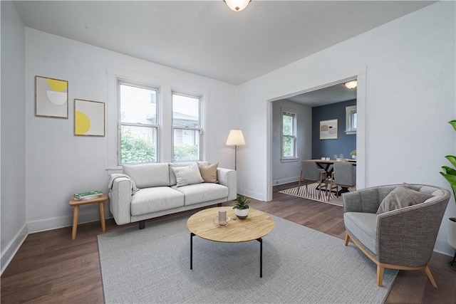 living area with wood finished floors and baseboards