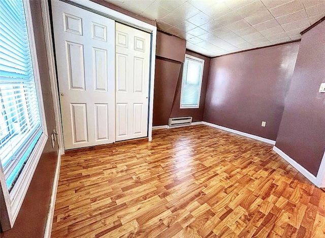 unfurnished bedroom featuring a closet and light hardwood / wood-style floors