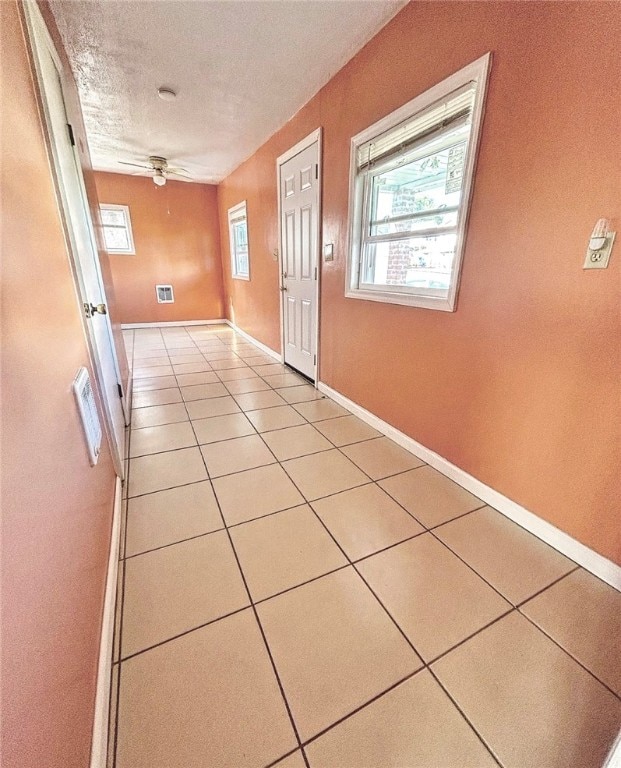 interior space featuring ceiling fan and light tile patterned floors