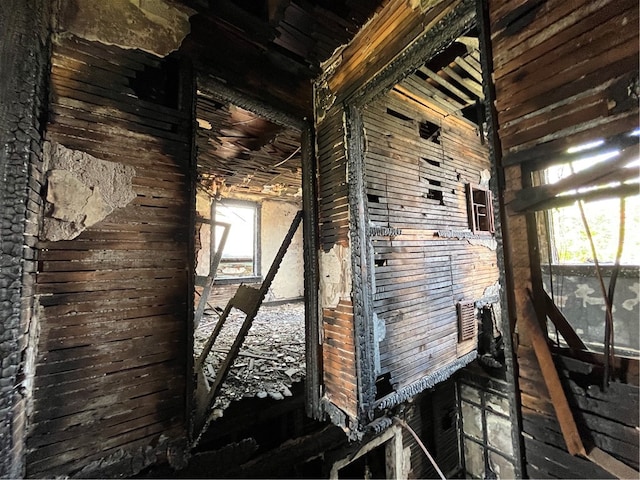 misc room featuring wood walls