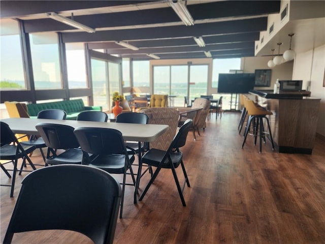 dining area featuring expansive windows and dark hardwood / wood-style floors