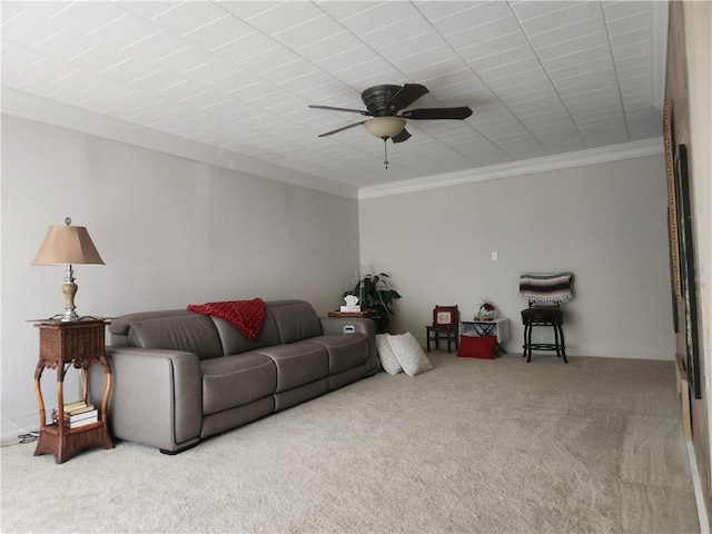 living room with carpet, ceiling fan, and ornamental molding